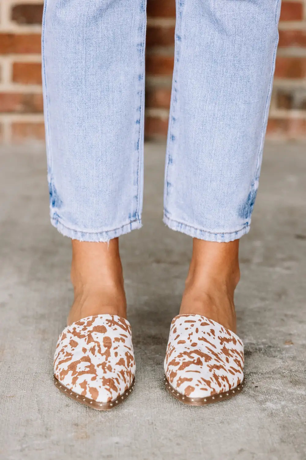 On Good Terms Tan Brown Cow Print Mules